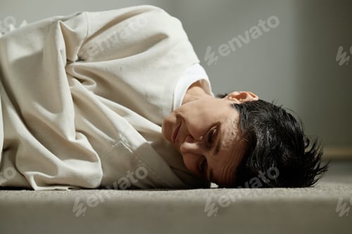 Preview: Adult Woman Lying on Floor in Psychiatric Care Concept