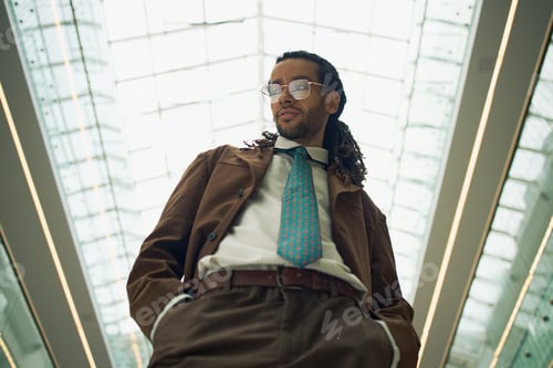 Preview: Adult Businessman Standing Confidently in Corporate Atrium