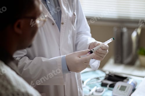 Preview: Doctor Preparing Insulin Pen during Diabetes Consultation