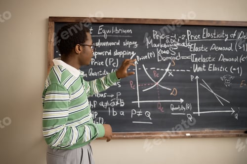 Preview: Black Teenage Boy Explaining Economics Graphs in Classroom