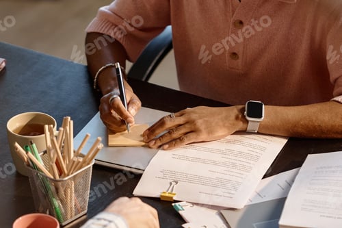 Preview: Black Man Writing Note during Business Meeting and Document Review