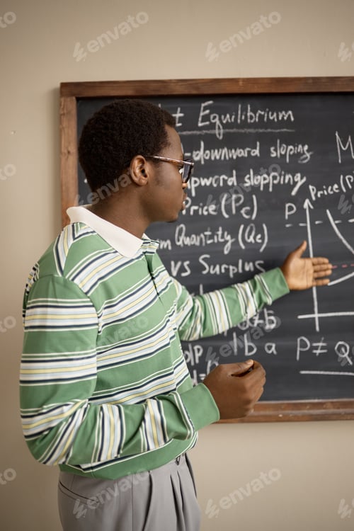 Preview: Vertical of Black Adult Man Explaining Market Equilibrium on Classroom Board
