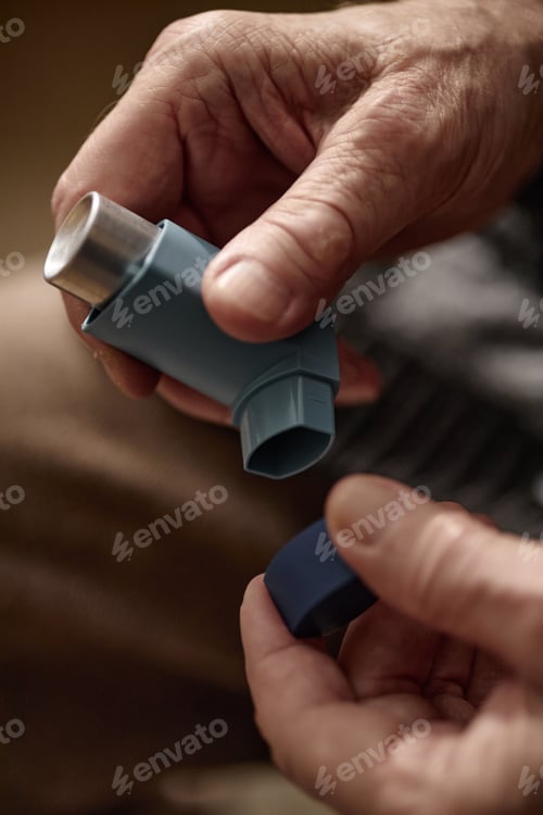 Preview: Senior Adult Hands Holding Asthma Inhaler for Respiratory Care