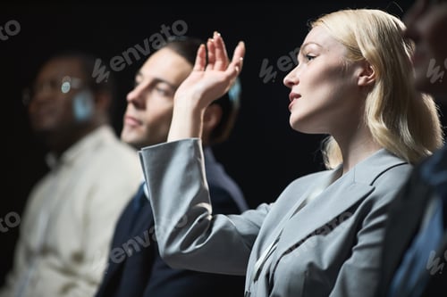 Preview: Businesswoman Raising Hand during Corporate Panel Discussion