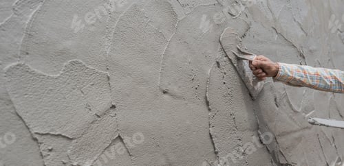 Preview: Hand worker plaster cement wall background with hand man holding work trowel handle and mix