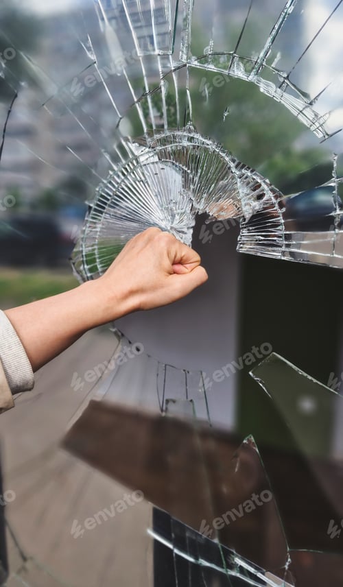 Preview: Fist demolishing windowpane. Fist punching thru a glass window