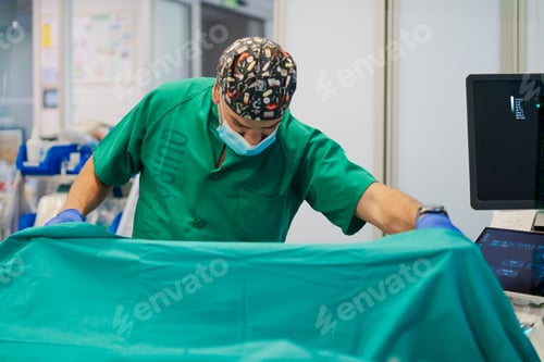 Preview: Surgeon wearing mask and scrubs preparing for surgery