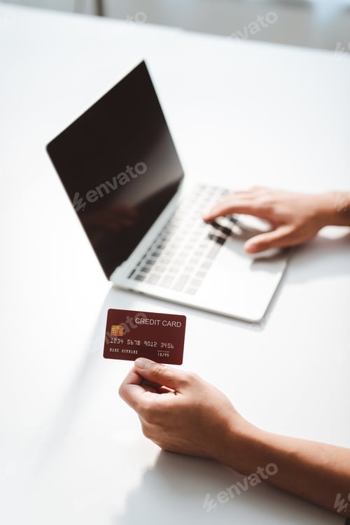 Preview: Person's hands entering card details on a laptop keyboard, completing a secure online payment for e-