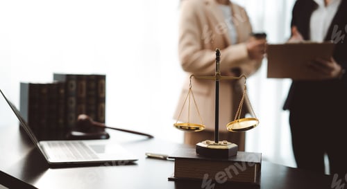 Preview: Legal professionals discussing client case in law office, with scales of justice, law books, laptop,