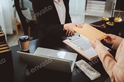Preview: Person giving an envelope filled with cash to another person, symbolizing bribery, illegal transacti