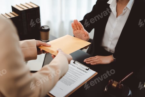 Preview: Person refusing a bribe, rejecting an envelope with illicit money, emphasizing integrity and ethical