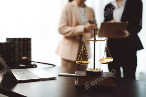Preview: Scales of justice symbolizing legal fairness, ethics, and equal rights on a desk with a laptop, book