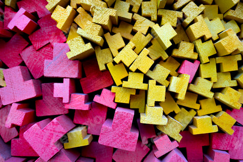 Preview: Abstract Background of Stacked Red and Yellow T-Shaped Wooden Blocks in a Dense Pattern