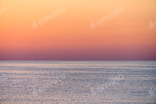 Preview: Calm sunset over tranquil ocean with soft pastel sky hues