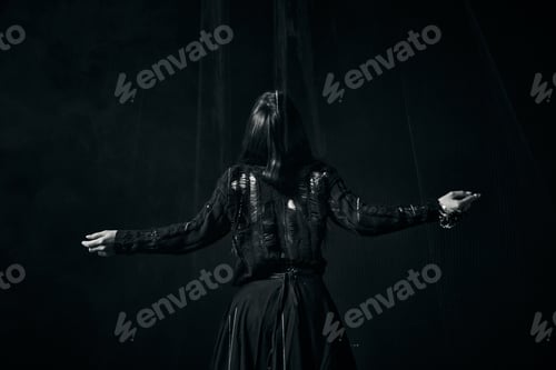 Preview: Young woman black clothing raised arms dark moody low lighting rear view