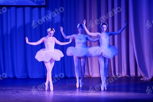 Preview: Three ballerinas performing swan lake ballet on stage with blue lighting and curtain backdrop