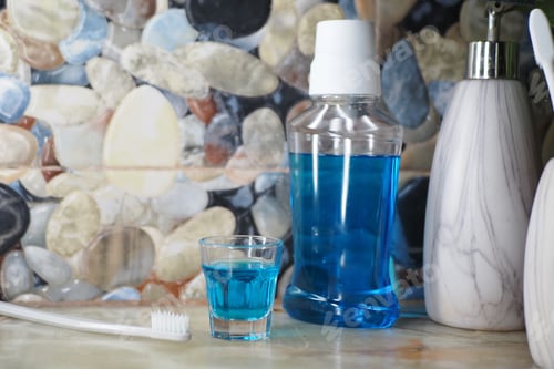 Preview: Oral hygiene setup with mouthwash and toothbrush on counter