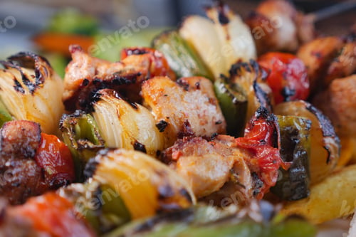 Preview: Grilled meat and vegetables on a skewer at a summer cookout