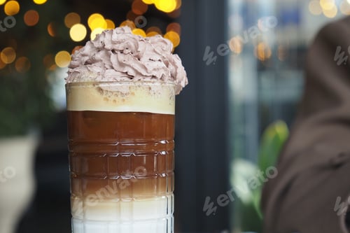 Preview: layered iced coffee drink appears to be a Freddo Cappuccino.