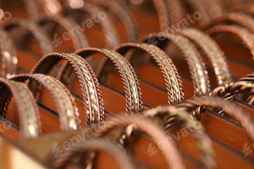 Preview: Fine metal bangles arranged on a wooden display board