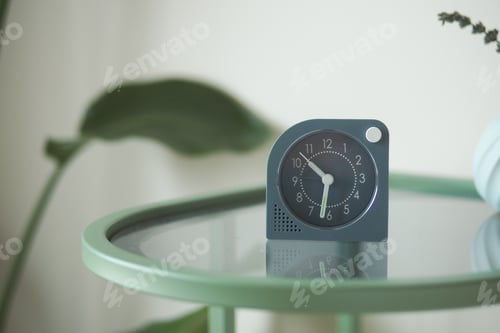 Preview: Simple clock on a green table in a bright room