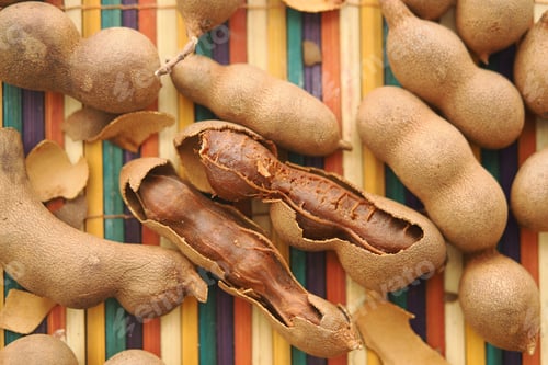 Preview: Tamarind pods on colorful bamboo mat