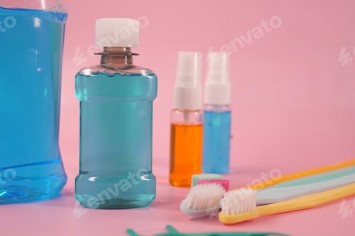 Preview: Oral care items on a pink background with blue drinks
