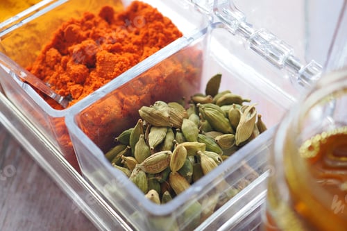 Preview: Spices arranged in clear containers on a wooden table