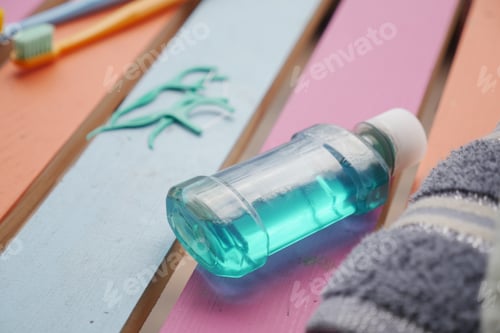 Preview: Mouthwash on colorful bathroom shelf in the morning