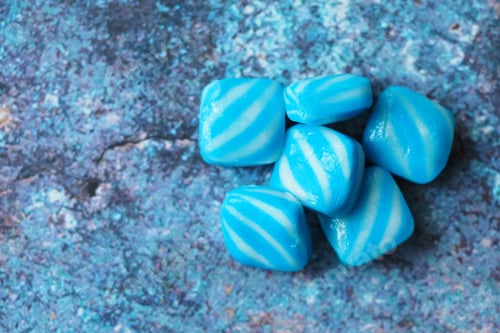 Preview: Colorful gummy candy pieces on a textured surface
