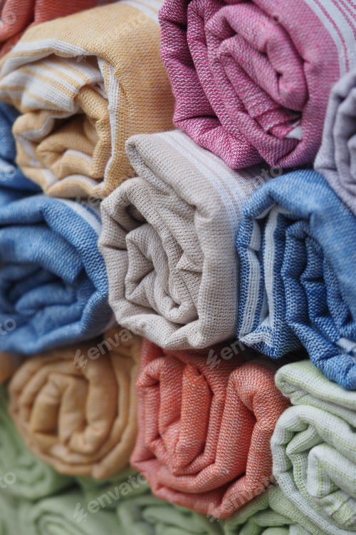 Preview: Colorful rolled towels stacked neatly in a display