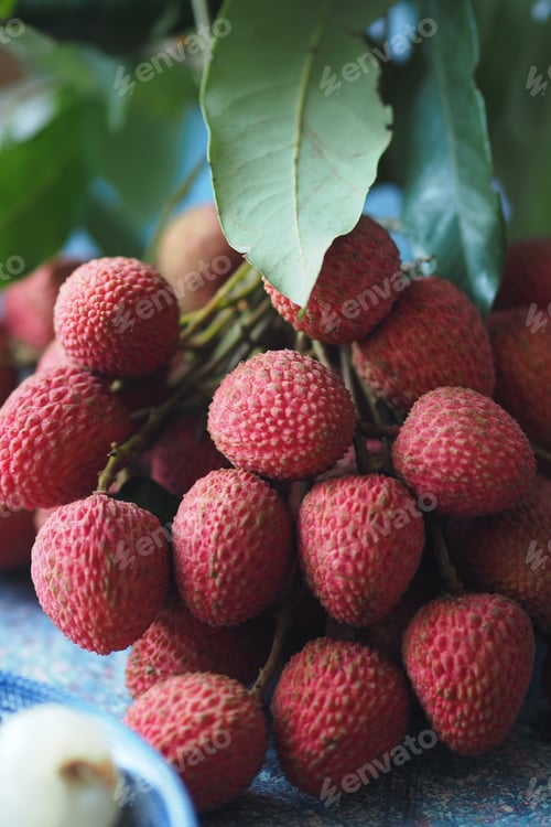 Vibrant Cluster of Fresh Ripe Lychees With Green Leaves