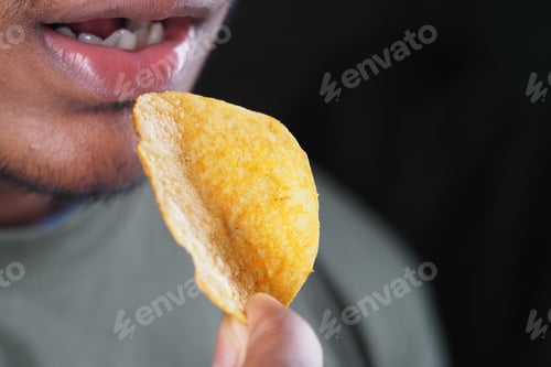 Preview: Person poised to bite a chip
