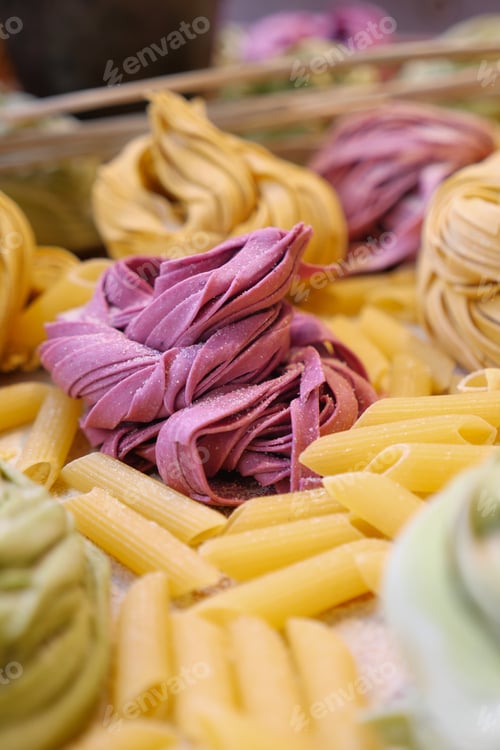 Preview: Different colors of pasta are arranged on a table