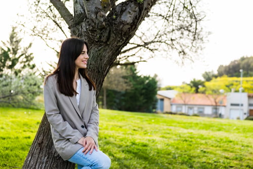Preview: Young woman smiling enjoying nature relaxing outdoors