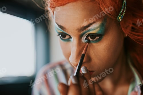 Preview: Man in drag applying eyeshadow, entertainment makeup look
