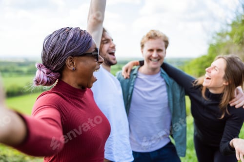 Preview: Group of diverse friends laughing outdoors, enjoying nature. Friends bonding, smiling, and having fu