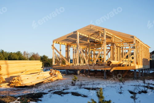 Preview: Wood frame house construction, timber framing stage, foundation piles, exterior view, building on si