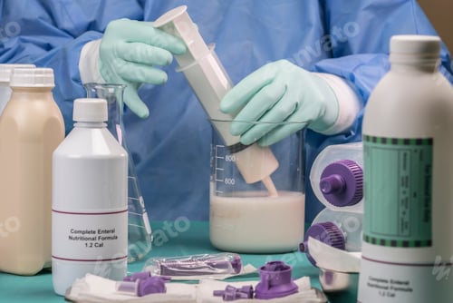 Preview: Nurse extracts enteral nutrition content with syringe, pailative care in a hospital