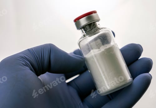 Preview: Detail of hand medical holding a vial, conceptual image