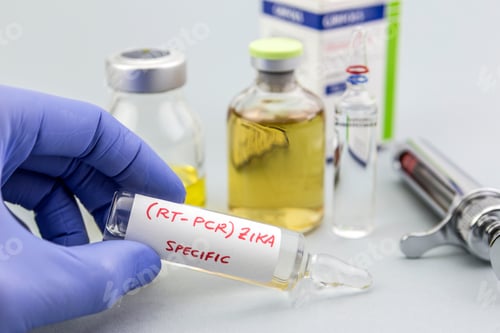 Preview: Scientist with blue latex gloves holds vials of ZIKA virus in laboratory for analysis