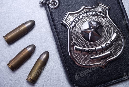 Preview: Police badge next to bullets, concept image