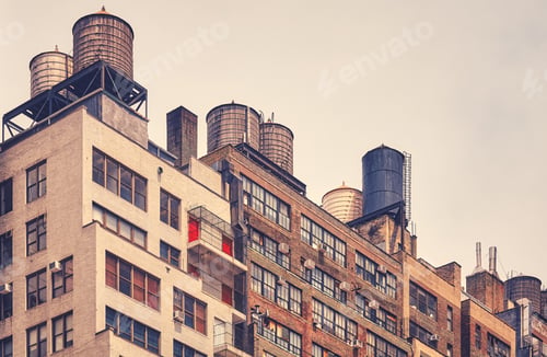 Preview: Water towers on a roof in downtown New York, color toning applied, USA.