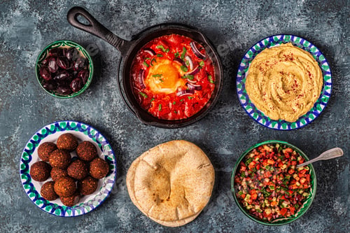 Preview: Falafel, hummus, shakshuka, Israeli salad - traditional dishes of Israeli cuisine.