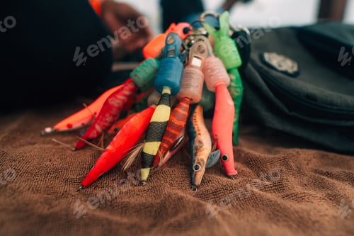Preview: Close-up of a colorful artificial fishing lure with sharp treble hooks.