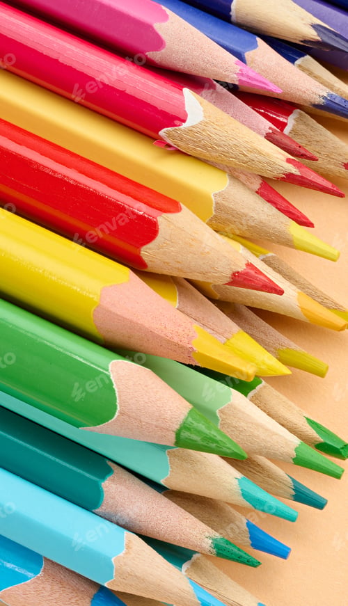 Preview: Multicolored wooden pencils stacked on a beige background