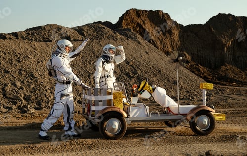 Preview: Mars exploration vehicle drives through rocky terrain with astronauts in space suits