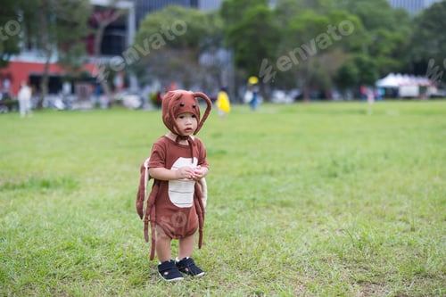 Preview: Baby dressed in Halloween costume pretending outdoors