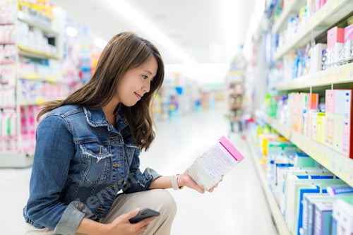 Preview: Woman shopping inside local grocery store aisle