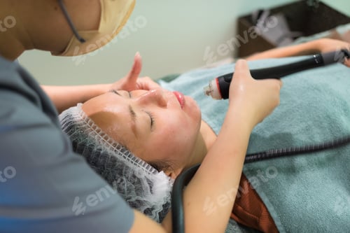 Preview: Woman enjoying facial treatment at beauty salon relaxing spa session